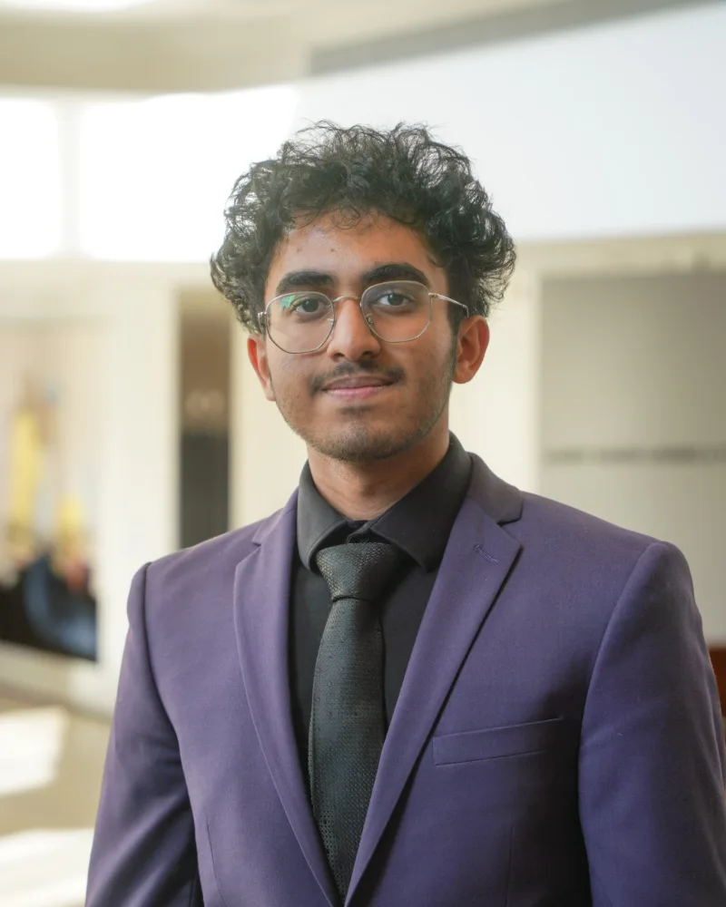 Ashwin Krishan in a purple blazer, smiling